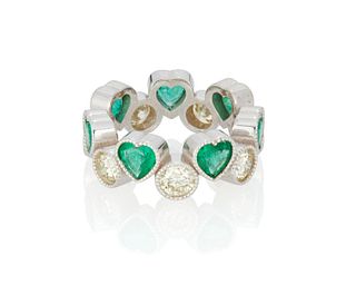An emerald and diamond heart ring