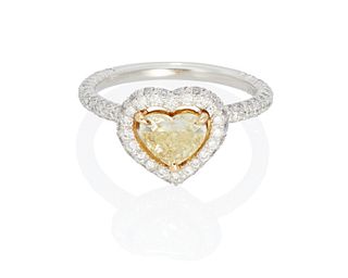 A fancy yellow and near colorless diamond ring