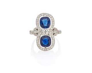 A twin stone sapphire and diamond ring