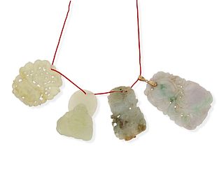 A group of carved jade pendants