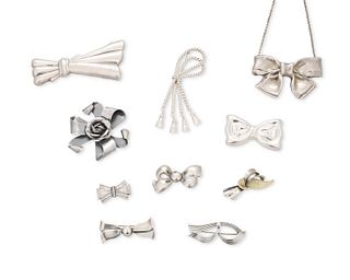 A group of silver bow brooches