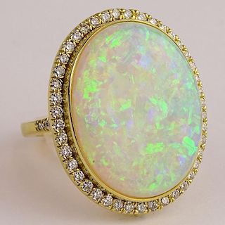 Lady's Fine Quality Approx. 20.0 Carat White Opal, 1.30 Carat Round Cut Diamond and 18 Karat Yellow Gold Ring. Opal with red, blue, green and yellow p