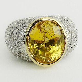 GIA Certified 12.18 Carat Oval Cut Natural Unheated Yellow Sapphire, Approx. 3.0 Carat Pave Set Round Cut Diamond and 18 Karat White Gold Ring.
