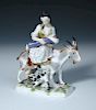 After Eberlein, a Meissen figure of the Tailor's wife, she suckles her child while riding a goat in
