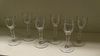 A set of six 18th century wines, each with cylindrical bowls rounding into the facetted stems on cir
