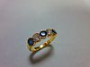 An 18ct gold, sapphire and diamond five stone ring, with two round brilliant cut diamonds spacing th