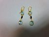 A pair of aquamarine and sapphire earrings, each gold wire hook suspending an articulated line of th