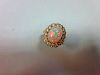 An opal and diamond cluster ring, the oval cabochon opal, displaying a rainbow range of fire, claw s