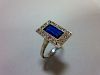 A mid 20th century sapphire and diamond ring, the rectangular step cut royal blue sapphire in a mill
