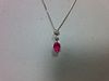 A pink sapphire and diamond pendant set in 18ct white gold, designed as a line of three stones separ