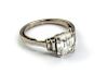 A diamond ring, the emerald cut principal stone, estimated weight 2.04cts, with two stepped baguette