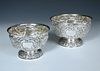 A small matched graduated pair of Edwardian silver rose bowls, one by Charles Stuart Harris, London