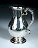 A George II silver ale jug, by Thomas Whipham, London 1775, of plain baluster shape, with leaf cappe