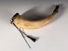 A late 18th or early 19th century powder horn, brass mounted, one end engraved with the crest of the