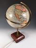A Geographia 10 inch electric terrestrial globe, on a lacquered brass support and moulded wooden bas
