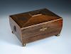An early 19th century rosewood workbox converted to a humidor, of sarcophagus form, on four gilt bra