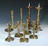 Four pairs and a single brass candlestick, the latter the earliest with dished drip pan, baluster co