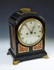 A Regency ebonised bracket clock by Desbois & Wheeler, London, the single pad top with brass handle,