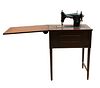 Lote de 2 muebles. SXX. Consta de Máquina de coser eléctrica. Estados Unidos, Marca Kenmore y mesa de centro en madera.