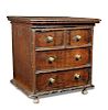 A small 17th century oak chest, a hinged top with false drawer fronts and brass handles, on later tu