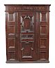 A 17th century Flemish oak panelled armoire, the frieze carved with monogram and date 1694, a centra