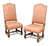 A pair of late 17th century style walnut side chairs, upholstered in pink damask fabric, on scroll c