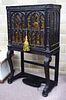 A Regency gothic revival black lacquer cabinet on stand, decorated in gilt with Chinoiseries in arch