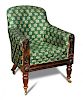 A late Regency rosewood library armchair, button upholstered in a green patterned fabric, the show w