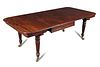 A William IV mahogany extending dining table, in the manner of Gillow, with drop leaf ends, one addi
