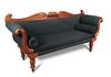 A late Regency mahogany sofa, scroll and gadroon carved show wood, upholstered in a black fabric wit