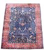 A Sparta blue ground carpet, decorated with branch and foliate designs within a dark pink border 597