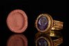A GOLD RING WITH ROMAN AMETHYST INTAGLIO DEPICTING SOL INVICTUS