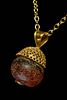 A GREEK HELLENISTIC PENDANT WITH GARNET AND GOLD FILGREE HAT
