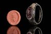 A ROMAN BRONZE RING WITH CARNELIAN INTAGLIO DEPICTING BUST OF IMPERIAL FAMIL