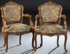 Pair of Louis XV Style Carved Giltwood Fauteuils, 20th c., the arched floral carved curved upholstered back to upholstered arms and a bowed upholstere