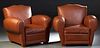 Pair of French Art Deco Brown Faux Leather Club Chairs, 20th c., the canted serpentine back over rolled arms flanking a removable cushion seat, on blo