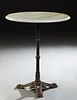 French Parisian Onyx Top Cast Iron Bistro Table, 20th c., the ogee edge circular top on a reeded tapered support, to a tripodal base with paw feet, H.