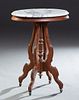 American Carved Walnut Marble Top Lamp Table, early 20th c., stepped ogee edge white marble over a reeded figural skirt on four cabriole legs around a
