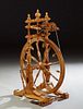 French Provincial Carved and Turned Beech Treadle Spinning Wheel, 19th c., with a pedal mechanism, H.- 40 in., W.- 16 1/2 in., D.- 27 in.