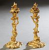 Pair of Continental Gilt Bronze Figural Candlesticks, 19th c., the nude female upholding a shell form bobeche with a floriform candle cup with a fruit