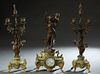 Three Piece Patinated Spelter and Green Onyx Figural Clock Set, c. 1900, with a Madrassi figural group "Jeune Mere," over a painted dial time and stri