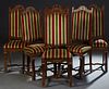 Set of Six Spanish Renaissance Style Dining Chairs, 20th c., the tall arched floral carved canted upholstered back, over a trapezoidal cushioned seat,