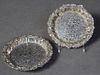 Pair of English Sterling Bottle Coasters, 19th c., the relief shell, scroll, and leaf decorated rim, around an incised decorated center engraved with 