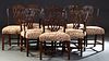Eight (6+2) Carved Mahogany Chippendale Dining Chairs, 20th c., the arched crest rail over an intertwined pierced leaf carved vertical splat to cushio