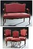 French Louis XV Style Carved Walnut Four Piece Parlor Suite, 19th c., consisting of a pair of fauteuils, a side chair and a settee, the arched C-scrol