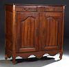French Provincial Louis XV Style Carved Walnut Sideboard, early 19th c., the stepped canted corner top over two reeded frieze drawers with iron heart 