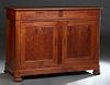 French Provincial Louis Philippe Carved Cherry Sideboard, 19th c., the canted corner rounded edge top over two large setback frieze drawers, on a plin