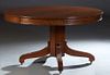American Classical Carved Mahogany Dining Table, 19th c., the circular top over a wide skirt, on a hexagonal support with reeded arched legs on caster