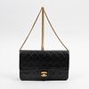 Chanel Classic Single Flap, c. 1986, in black quilted lambskin leather with golden hardware, opening to a black and burgundy lined leather interior wi