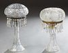 Two Cut Glass Mushroom Lamps, 20th c., one with a floral etched shade on a tapered floral etched base, prism hung; the second with a hobnail cut shade